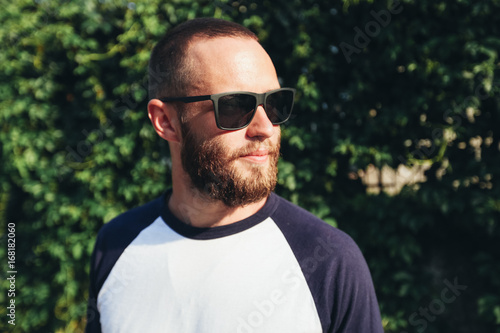 Hipster man wearing black sunglasses in urban city streets