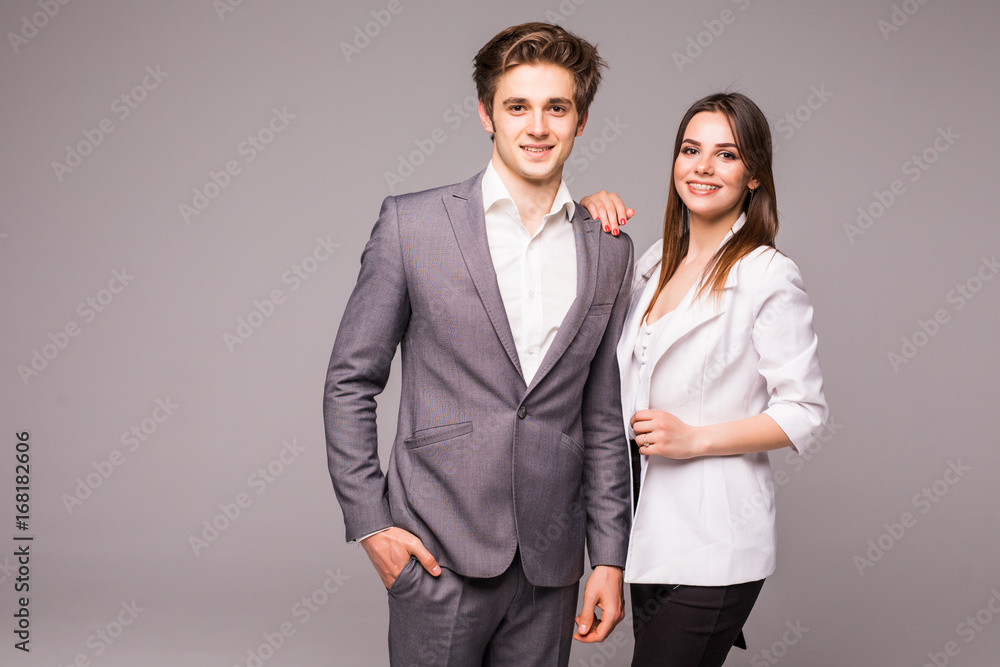 Young smiling business woman and business man on grey background