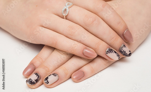 Nail Care And Manicure. Closeup Of Beautiful Female Hands Applying Transparent