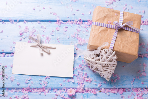 Wrapped box with present, empty tag and decorative white heart
