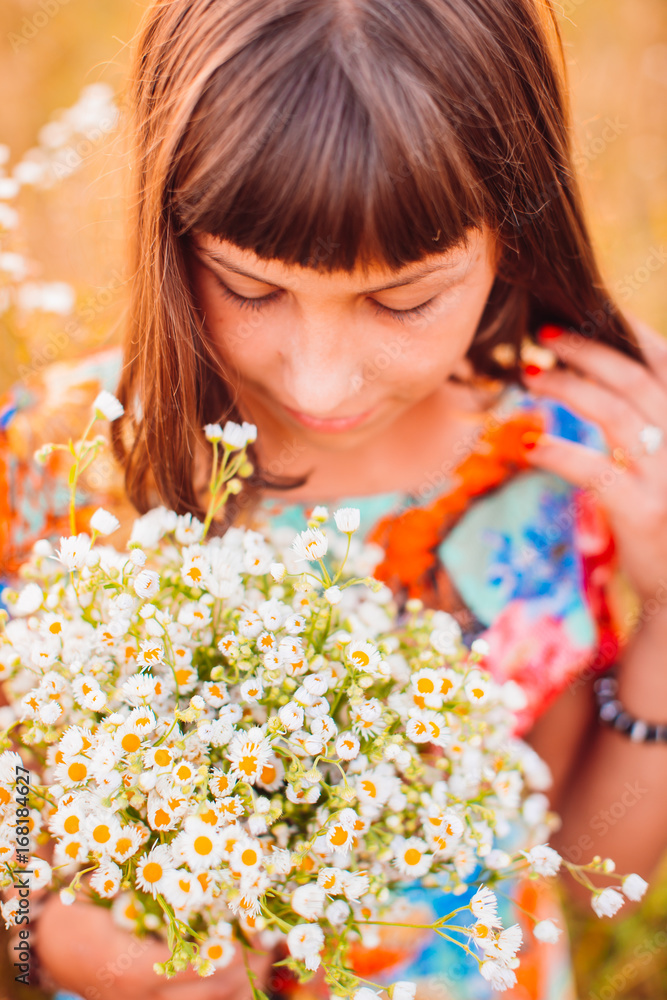 Girl with daisies stands on the field Girl with daisies stands on the field