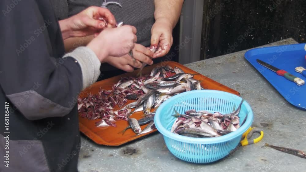 Fish Seller Cleans and Cutting Fresh Fish in Fish Market. Manual cleaning of fish. Gut