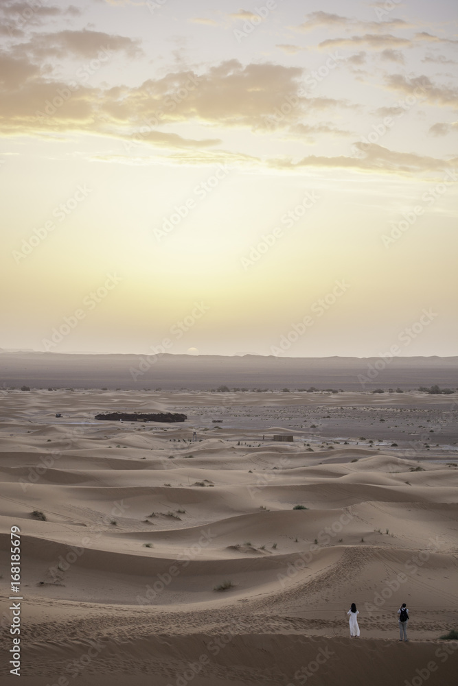 Sunrise in desert with people in front, Erg Chebbi, Morocco