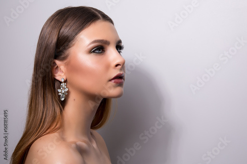 Fashionable portrait of a girl model. Fashion, accessories, evening wet effect makeup.