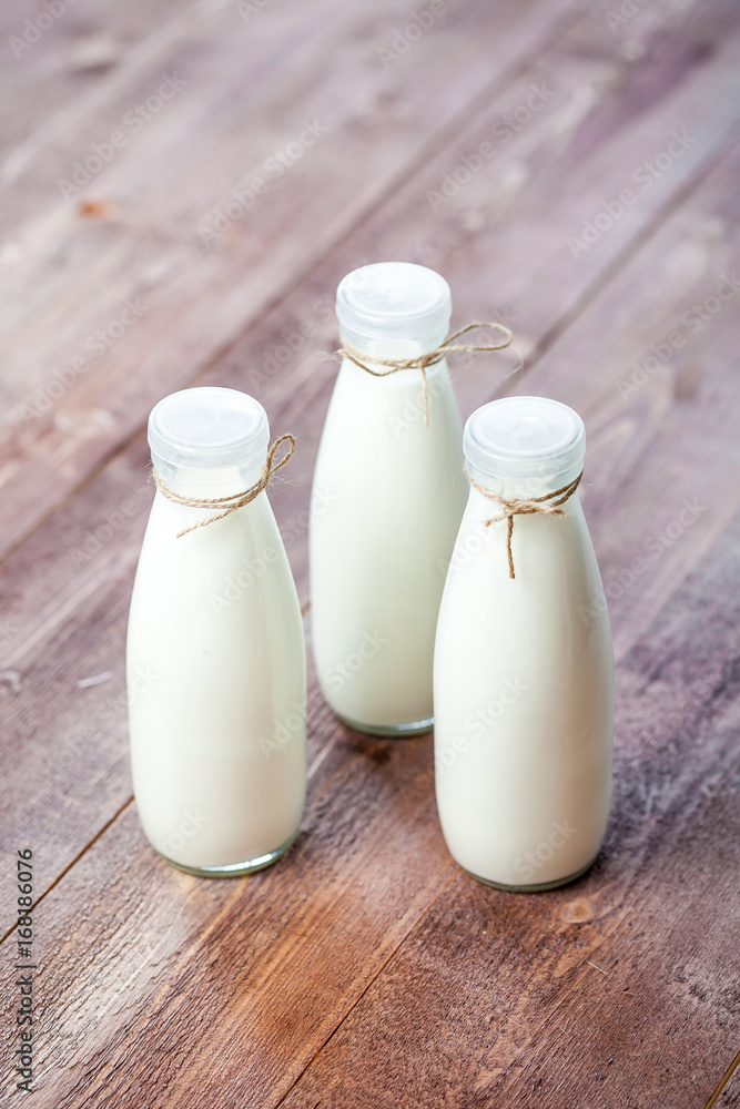 bottles of milk on a wooden rustic table. bottles of milk on a wooden rustic table.