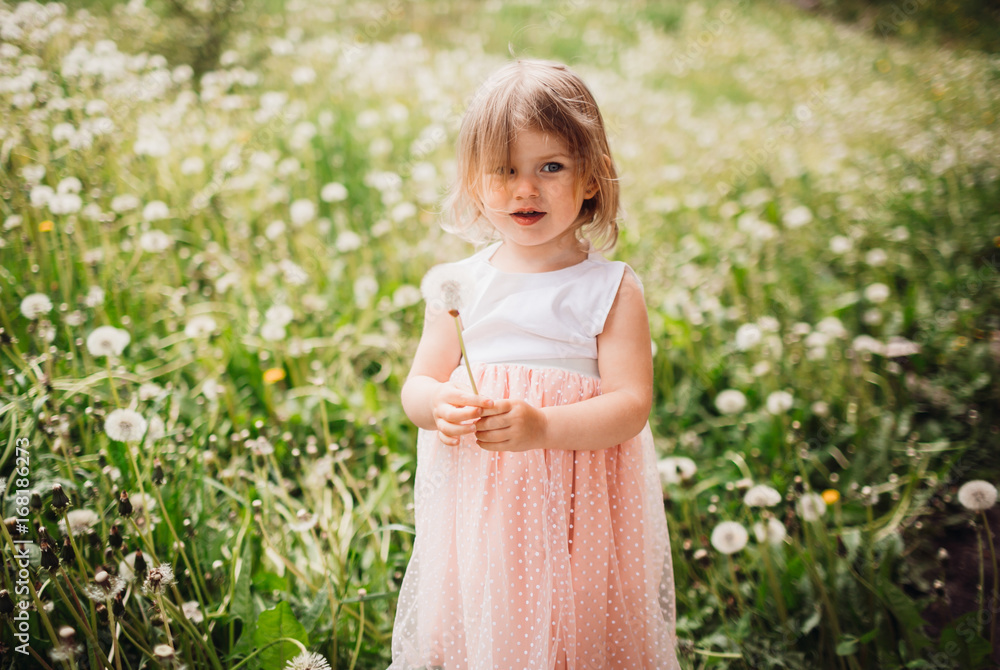 Pretty little girl pose on a green field Pretty little girl pose on a green field