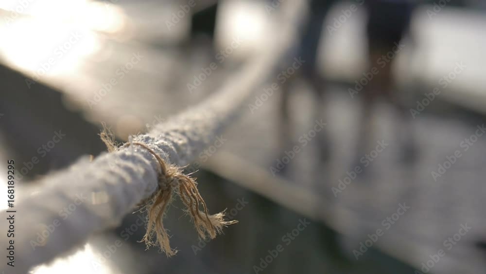 Nautical rope with people passing by in the background Nautical rope with people passing by in the background
