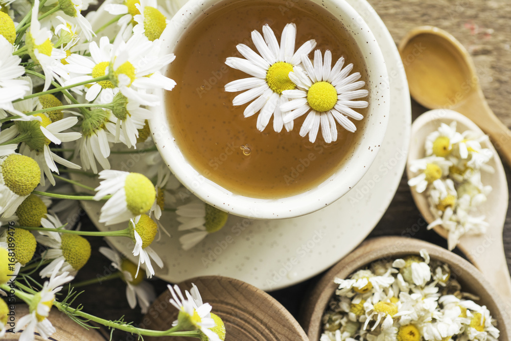 cup of herbal chamomile tea with camomile dry blossoms, dried camomile flowers. doctor treatment and prevention of immune concept, medicine - folk, alternative, complementary, traditional medicine cup of herbal chamomile tea with camomile dry blossoms, dried camomile flowers. doctor treatment and prevention of immune concept, medicine - folk, alternative, complementary, traditional medicine