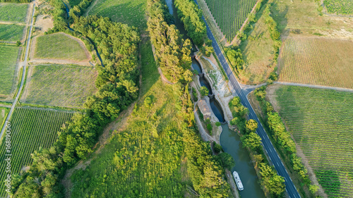 Aerial top view of Canal du Midi and vineyards from above, beautiful rural countryside landscape of Southern France 