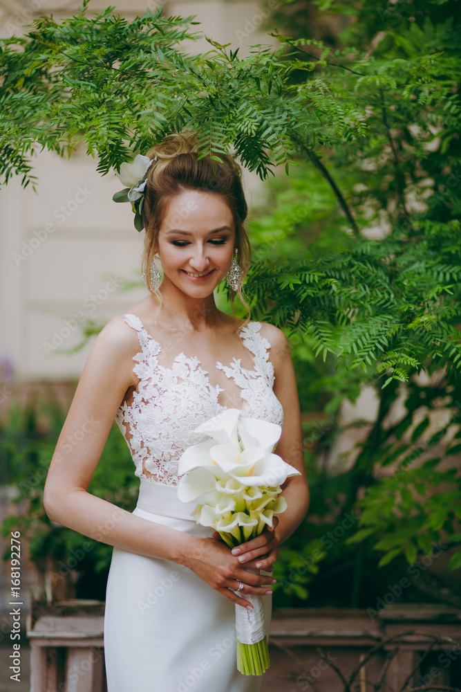 Beautiful bride in a wedding dress for a walk on the street Beautiful bride in a wedding dress for a walk on the street