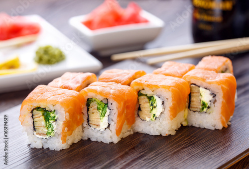 Beautifully decorated sushi on a wooden board.