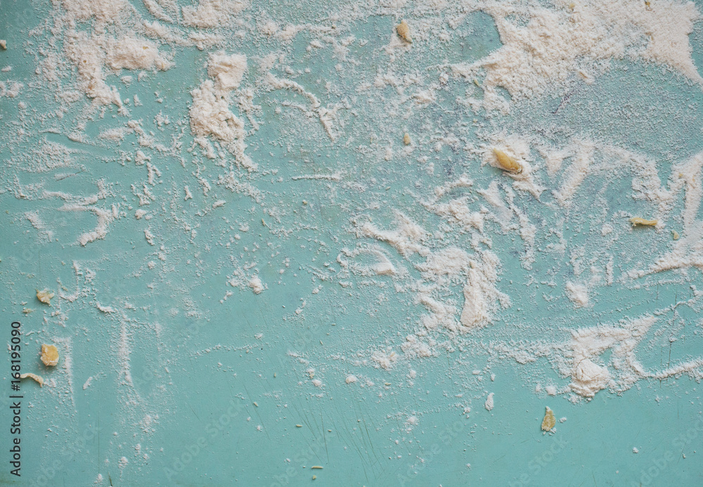 flour sprinkled on the blue table 