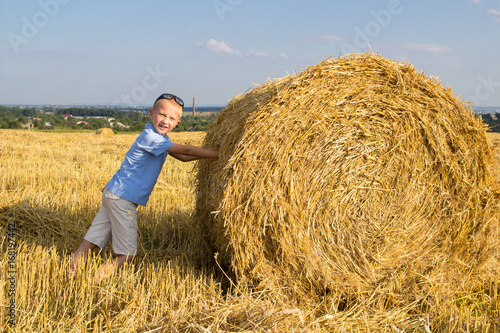 Boy near a hay bale