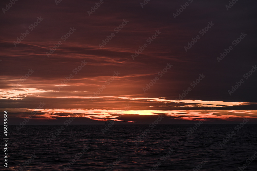 Beautiful red sunrise in the northern summer sea