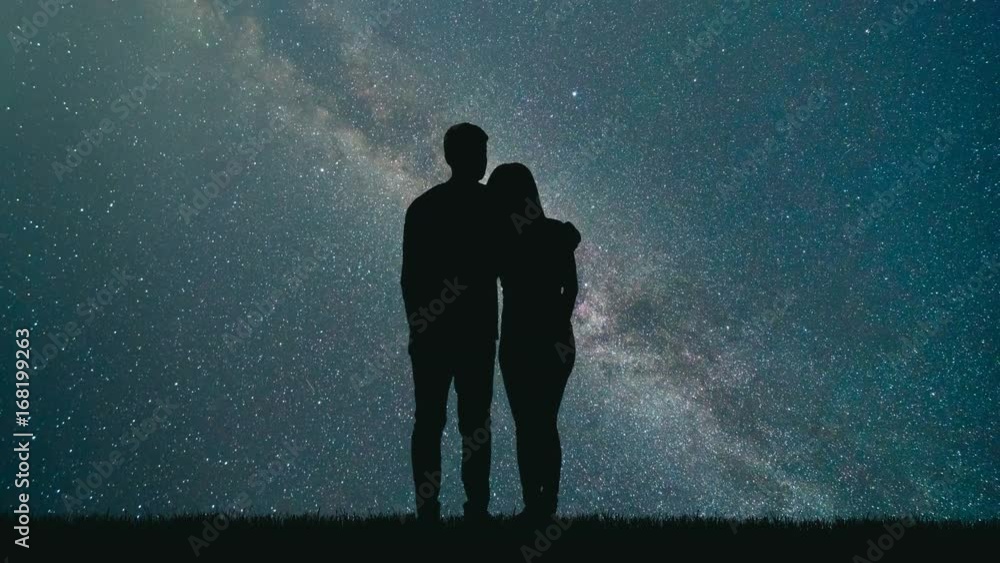 The man and woman look to meteor shower in the sky. time lapse The man and woman look to meteor shower in the sky. time lapse