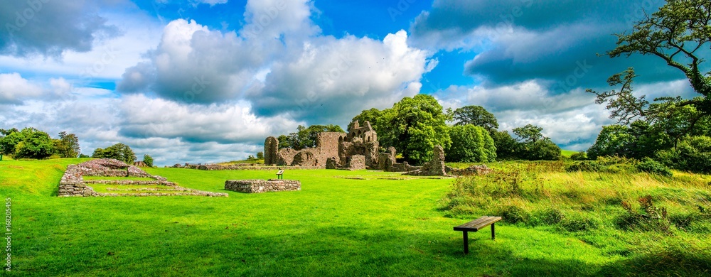 Inch Abbey with a blue sky in Northern Ireland. Monastery ruins in Downpatrick. Co. Down. Travel by car in summer.