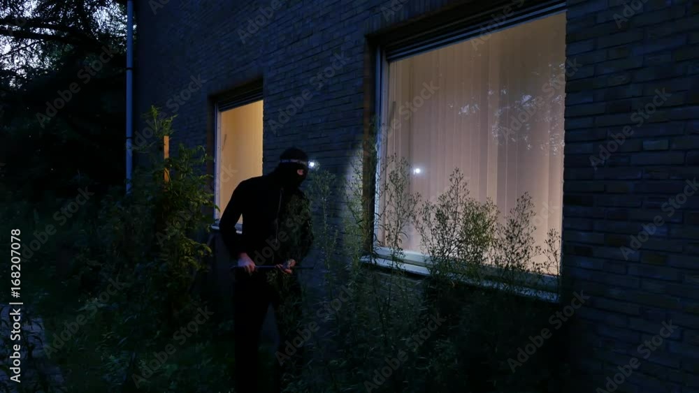 Burglar using crowbar to break into a house at night – 4K Burglar using crowbar to break into a house at night – 4K