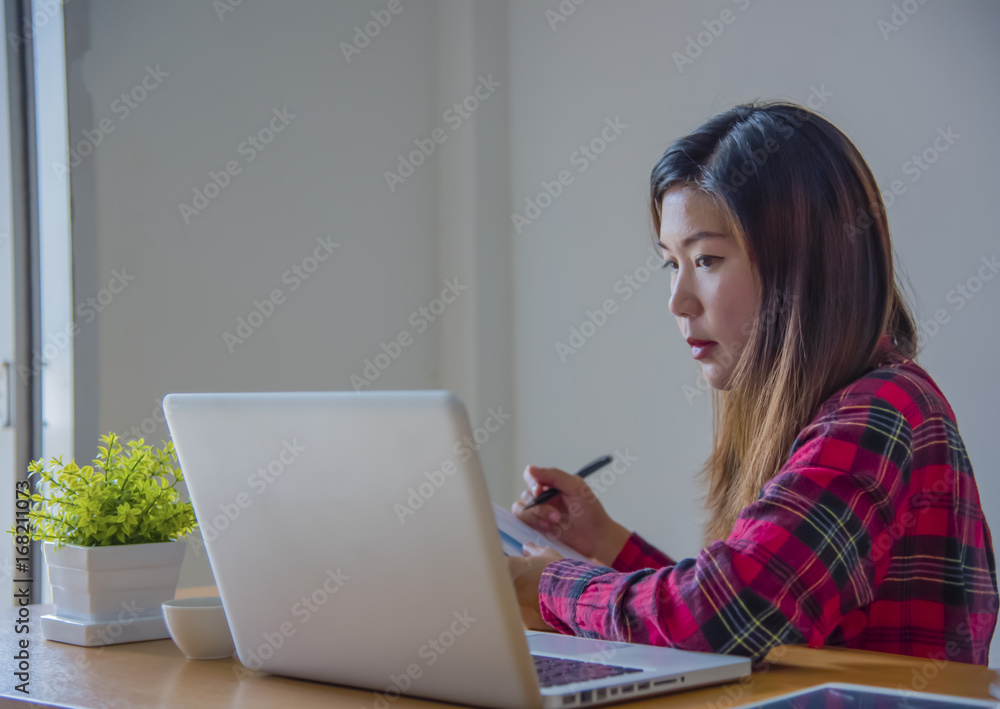 Business woman working at office with laptop, tablet and graph data documents on his desk. Business woman working at office with laptop, tablet and graph data documents on his desk.