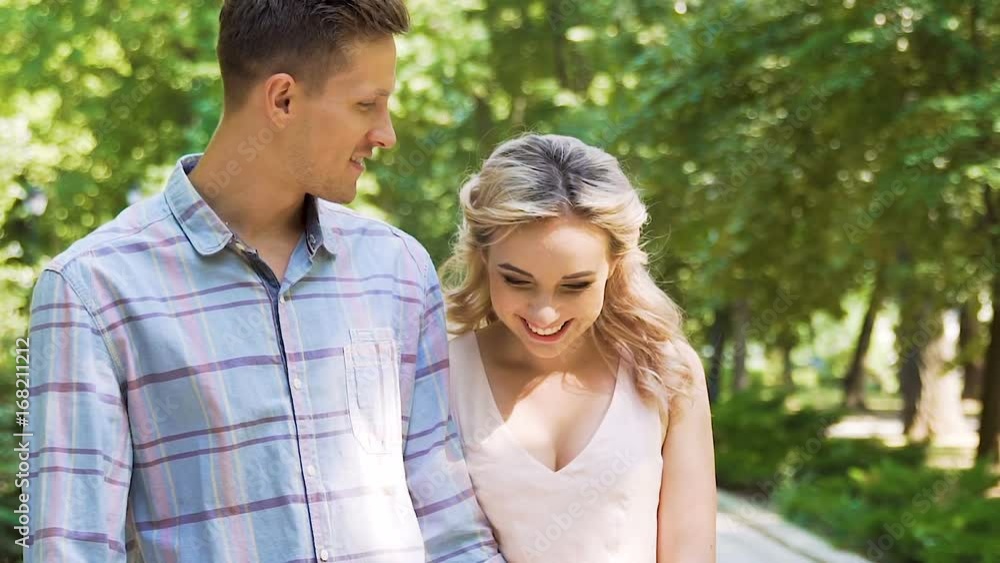 Happiness of man and woman in love walking together with smiles on young faces Happiness of man and woman in love walking together with smiles on young faces