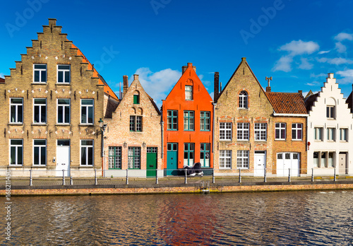 Brugge (Bruges), Belgium. Colored houses in the traditional architecture style and canal with water.