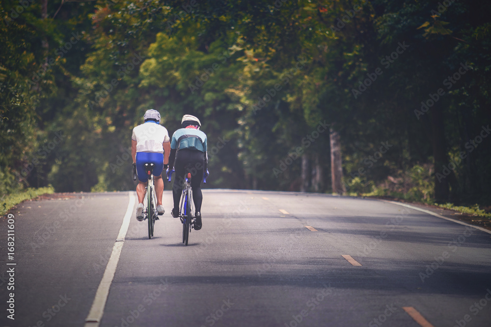Naklejka premium couples of man riding touring bicycle on mountain road