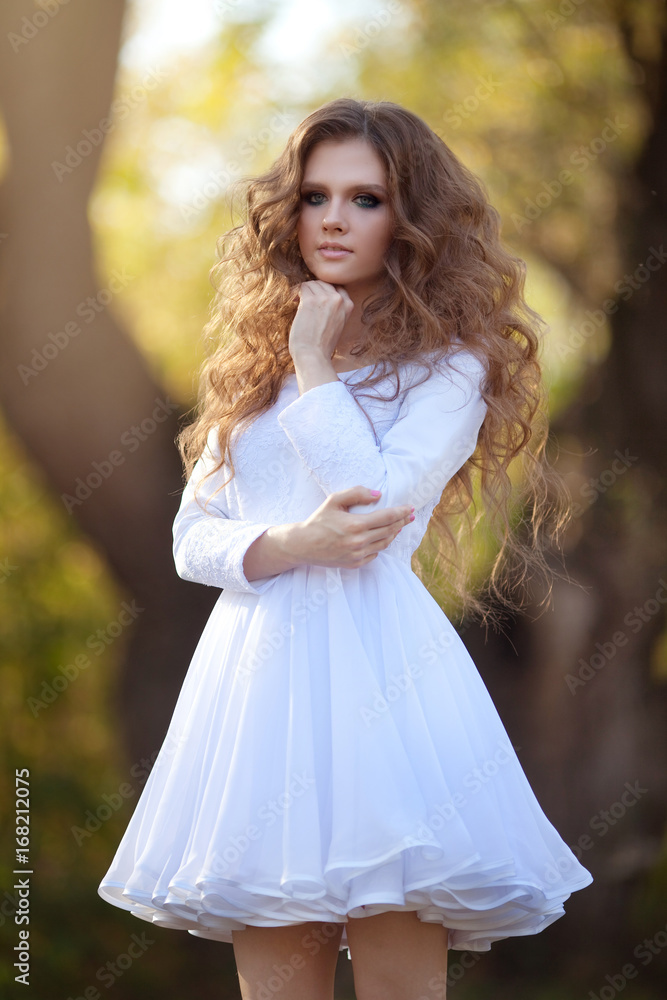 Beautiful young girl with makeup and hair-dress on a background of autumn forest Beautiful young girl with makeup and hair-dress on a background of autumn forest