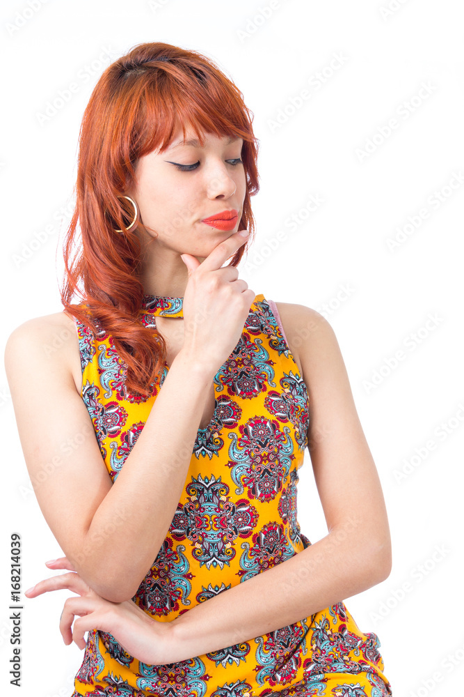 Girl assesses with hand on chin. She is analyzing. Young redhead woman with summer dress.. Girl assesses with hand on chin. She is analyzing. Young redhead woman with summer dress..