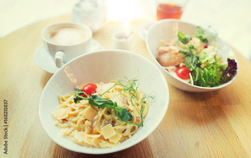 close up of pasta in bowl on table at restaurant close up of pasta in bowl on table at restaurant
