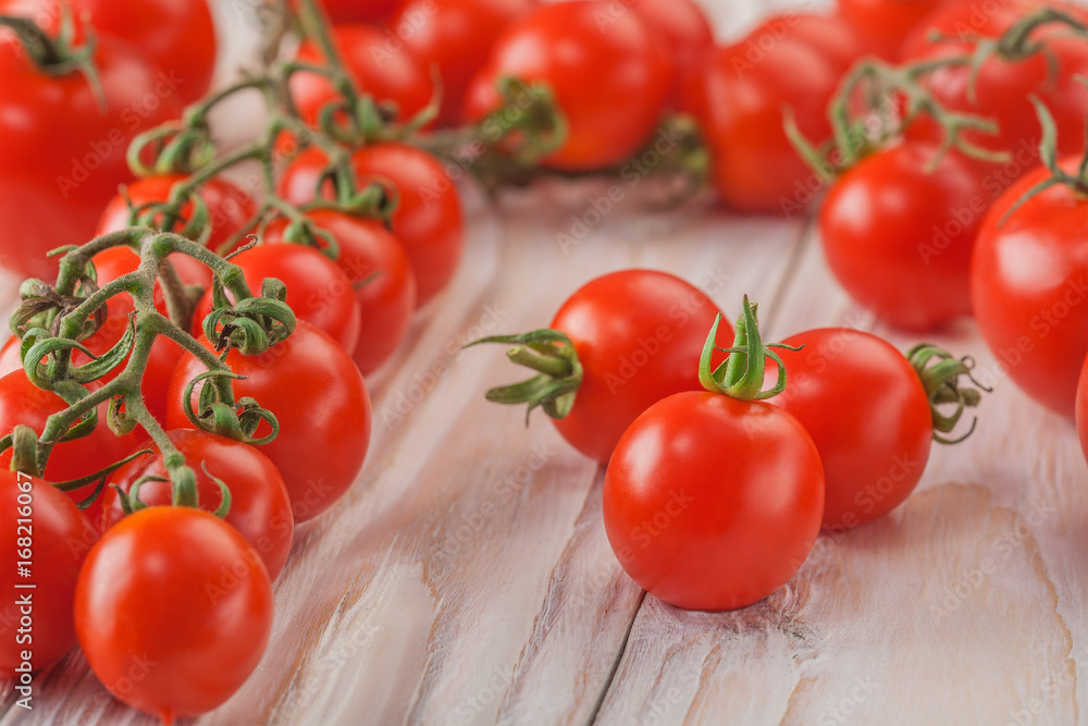 on a wooden background cherry tomatoes on the branches on a wooden background cherry tomatoes on the branches