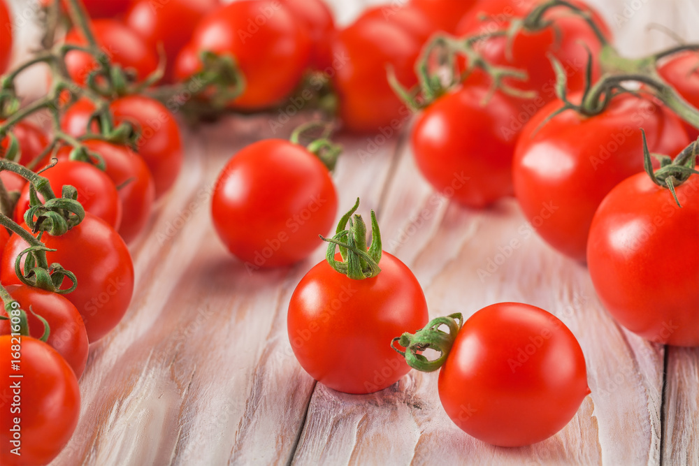 on a wooden background cherry tomatoes on the branches on a wooden background cherry tomatoes on the branches