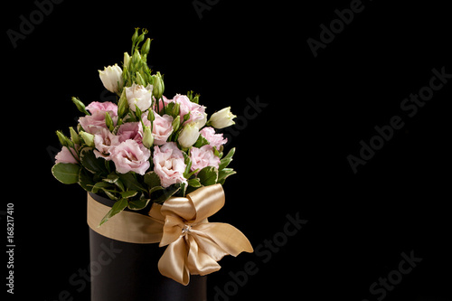 Bouquet of pink and white roses on a black background
