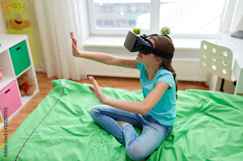 happy girl in vr headset or 3d glasses at home © Syda Productions