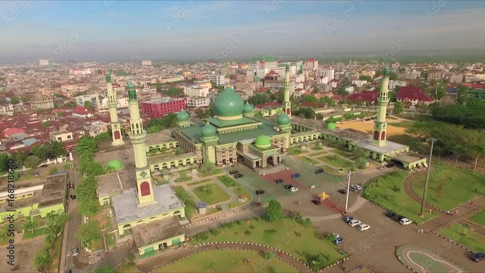 Aerial view of An-Nur Great Mosque in Pekanbaru city. Shot with drone on sunny day with blue sky in Sumatra, Indonesia, fly forward. Aerial view of An-Nur Great Mosque in Pekanbaru city. Shot with drone on sunny day with blue sky in Sumatra, Indonesia, fly forward.