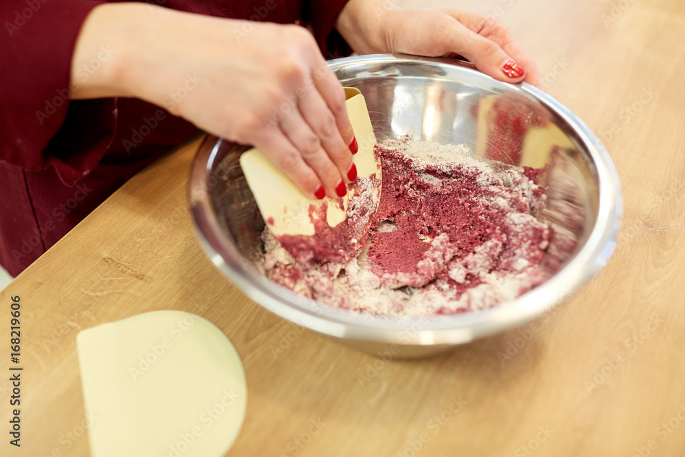 chef making macaron batter at confectionery chef making macaron batter at confectionery