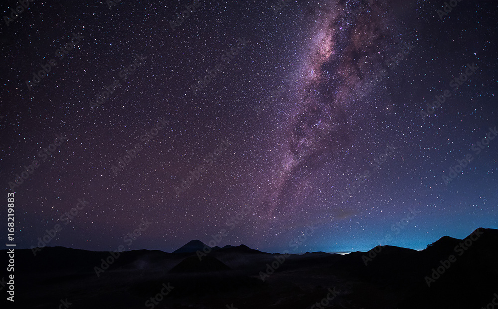 Landscape with Milky way galaxy over Mount Bromo volcano (Gunung Bromo) in Bromo Tengger Semeru National Park, East Java, Indonesia. Night sky with stars. Long exposure photograph.