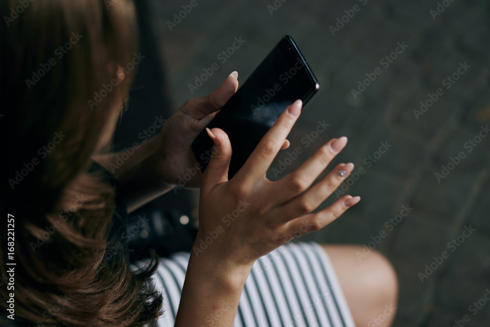 Woman holding a phone, close-up, hands, nails