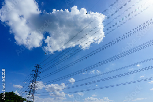 electricity transmission pylon with blue sky and cloud when sunny