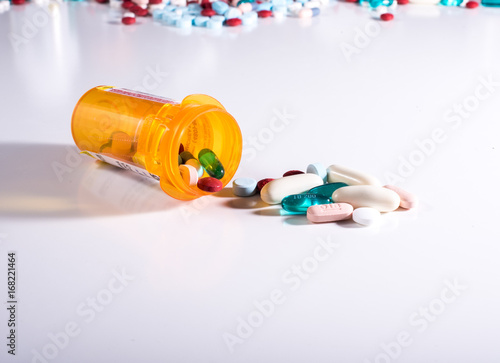 Pill bottle spilling a variety of medications