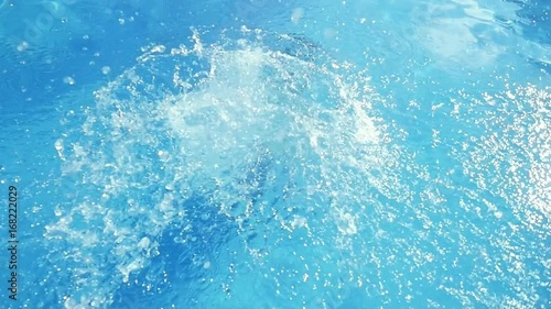 Young slim beautiful woman in pink bikini jumping into swimming pool in slow motion and water splashing on beautiful bokeh droplets . 1920x1080, hd