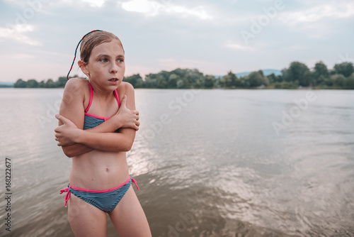 Girl shivering after a swim in the river