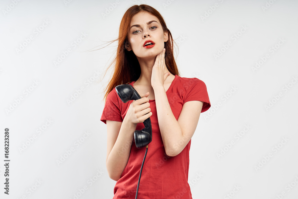 Woman on a light background holding a phone, communication, blank space to copy Woman on a light background holding a phone, communication, blank space to copy