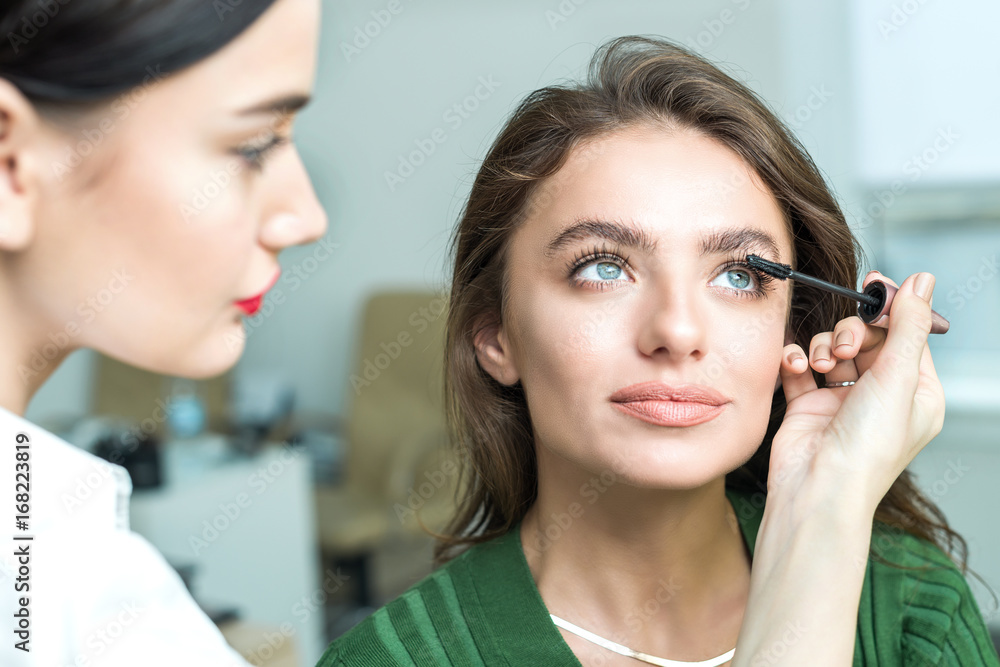 Brush applying beige makeup Brush applying beige makeup