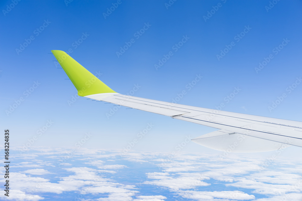 Obraz premium aircraft during flight wing blue sky clouds sunny