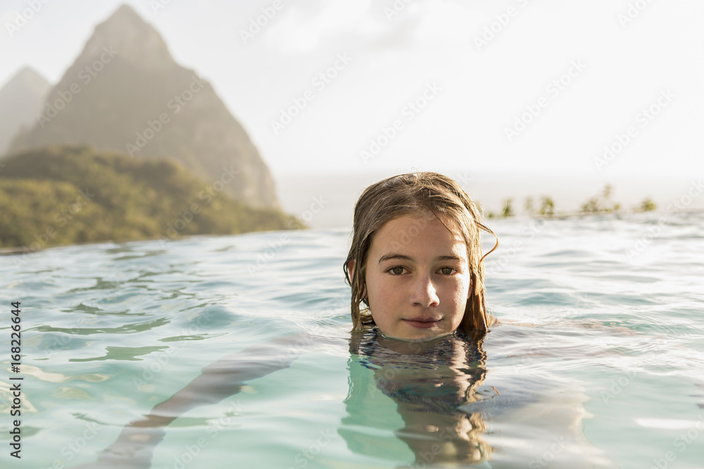 Girl swimming in infinity pool Girl swimming in infinity pool