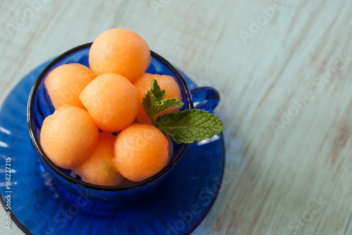 Cantaloupe Balls In Blue Teacup photo