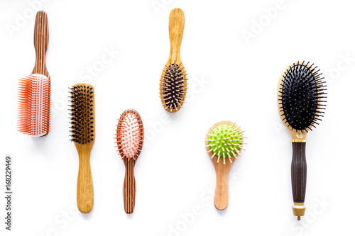 Set of combs in beauty salon on white background top view