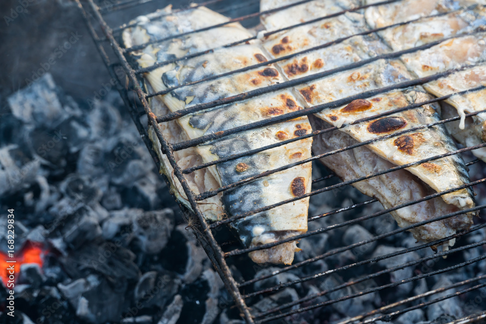 Preparation of fish on the grill. The smoldering of coals