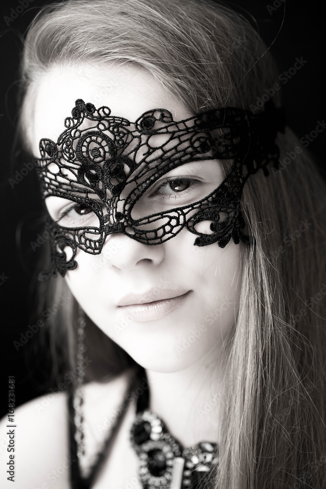 Obraz premium The smiling model in a black mask on a face