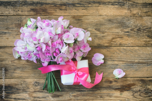 delicate bouquet of sweet peas and gift box