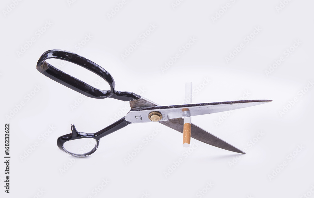 Cut cigarette with scissers and stop smoking to save your health Cut cigarette with scissers and stop smoking to save your health